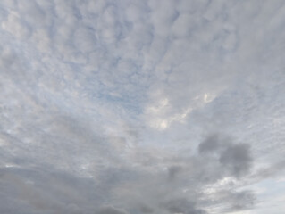 The sky is cloudy and the ocean is calm, Calm ocean waves rolling onto sandy beach under cloudy sky scenic view from above nature landscape seascape coastal scene