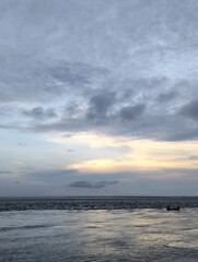 A beach with a cloudy sky in the background