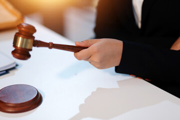 Judge gavel with Justice lawyers having team meeting at law firm background. Concepts of Law and...