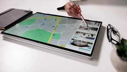 Young Woman Using Tablet To Search For Homes Online