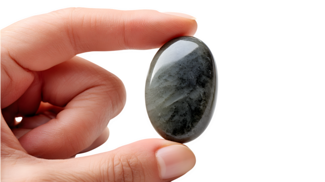 A smooth, polished worry stone held between two fingers, isolated on Transparent Background.