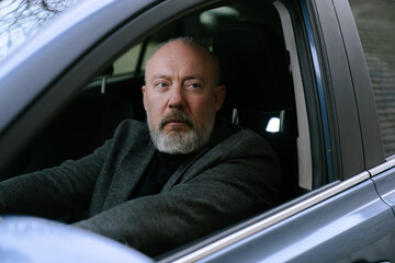 Elderly Man Driving a Car with Calm Expression