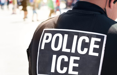 Ice police agent - Immigration and Customs Enforcement. Close up of POLICE ICE on the back of stab proof vest worn by DHS Department of Homeland Security police officer at the scene of incident