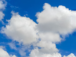 Bright blue sky with large, fluffy white clouds on a clear day