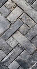 Obraz premium Gray stone paving bricks in herringbone pattern