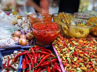 Colorful chili peppers and spices at a traditional market—ideal for culinary, food industry, or spicy cuisine themes. Vibrant and flavorful ingredients from Southeast Asia