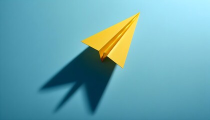 Minimalist flat lay of paper airplane on blue surface symbolizing growth, ambition, and creative direction