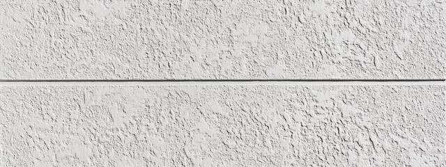 Two horizontal panels of textured white wall with a thin gray line separating them