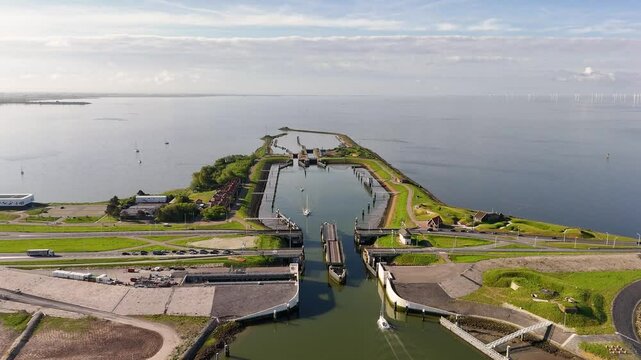 Kornwerderzand afsluitdijk: sailboat passing through the lorentz locks