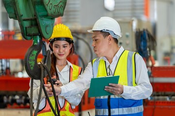 Factory apprenticeship. Man mentor teaching Female employees trainee operating machine looking...