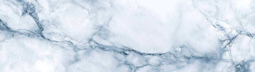 A close-up of a white marble surface with gray veins