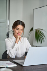 Fototapeta na wymiar Mature 45 years old professional business woman ceo manager using laptop in office. Busy female entrepreneur or executive of middle age working on computer technology sitting at work desk. Vertical