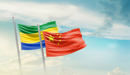 Gabon China friendship flags are waving in the sky. Two country flag for agreement or deal. Gabon...