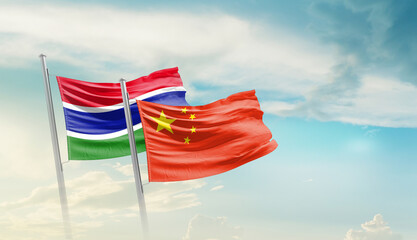 The Gambia China friendship flags are waving in the sky. Two country flag for agreement or deal....