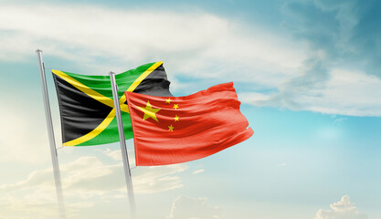 Jamaica China friendship flags are waving in the sky. Two country flag for agreement or deal. Jamaica China national flag for commitment.
