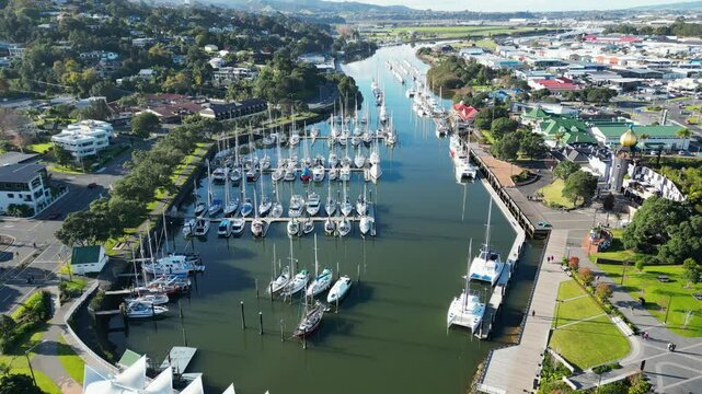 Drone view of scenic marina (Town Basin) with sailboats, paths and cafes in Whangarei, New Zealand.