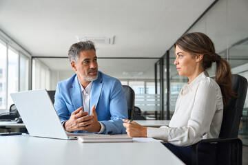 Professional executive team of two busy business partners of middle age working together on...
