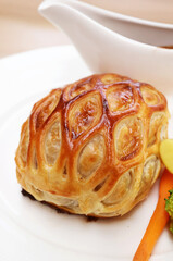 Closeup of a Plate of Delectable Beef Wellington Served with Red Wine Sauce