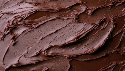 A close-up of smooth, rich brown chocolate spread, swirled and textured
