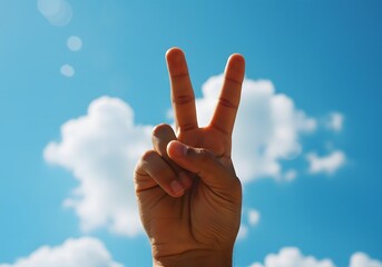 Peace Sign Hand Gesture Made With Two Fingers Raised Under Clear Daylight Outdoors