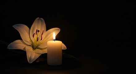 A lit white candle and a beautiful lily flower on a black background. The concept of commemoration and funeral. Memorial Day.