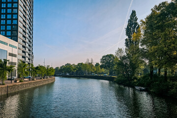 Canal river buildings sunny summer city scape landscape.