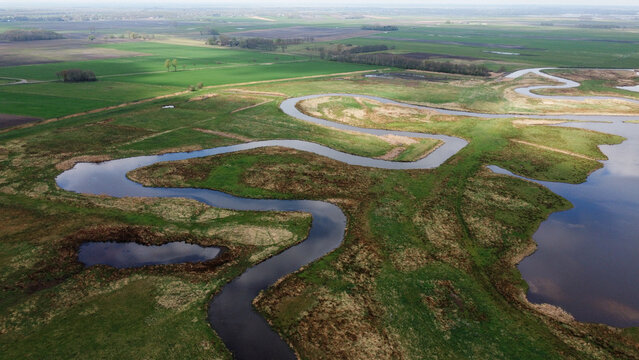 Rural river landscape nature aerial drone photo grass land and body of water stream. Dutch natural scene.