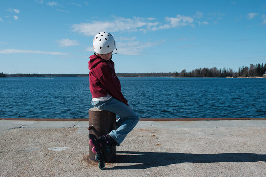 girl on roller blades by the sea playing on a sunny day