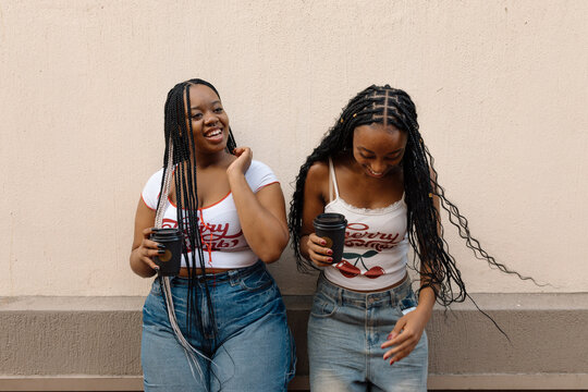 Sisters catching up over coffee on the street