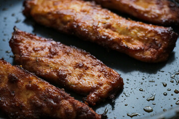 Chicken food close up in frying pan. Fresh juicy fried meat dinner prepared dish meal cooking grilling. 