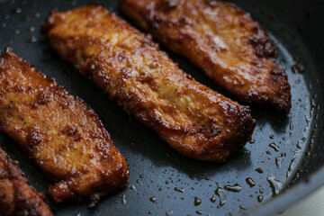 Juicy chicken in frying pan. Fresh fried meat dinner prepared dish meal cooking grilling with oil and butter.