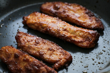 Chicken frying pan close up. Fresh juicy fried meat dinner prepared dish meal cooking grilling. 