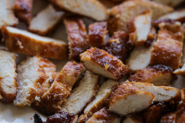 Slices of grilled chicken on plate. Fresh sliced meat dinner recipe food concept.