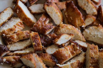 Chicken slices on plate close up. Grilled fried barbecue sliced meat dinner recipe