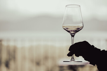 Hand holding an empty wineglass