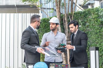Two Businessman and power engineering talking and checking quality power solar cell with laptop computor on site new project power solution business