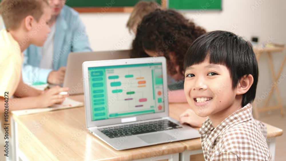 Poster energetic asian boy coding program and looking at camera in stem class while caucasian teacher and d