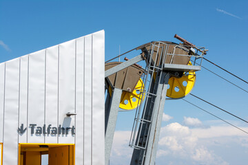 Modern cable car station at Nebelhorn with bold yellow pulleys and sleek architecture stands...