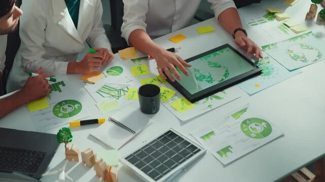 Close up of business people hands write notes about sustainable energy and environmental idea. Group of diverse people taking a note and brainstorming about green tech. Focus on hand. Alimentation.