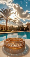 Obraz premium Golden bracelet on marble near pool, sunlight