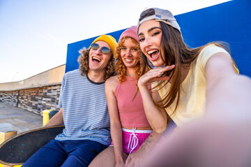 Group of cheerful skaters taking a selfie after a skating session