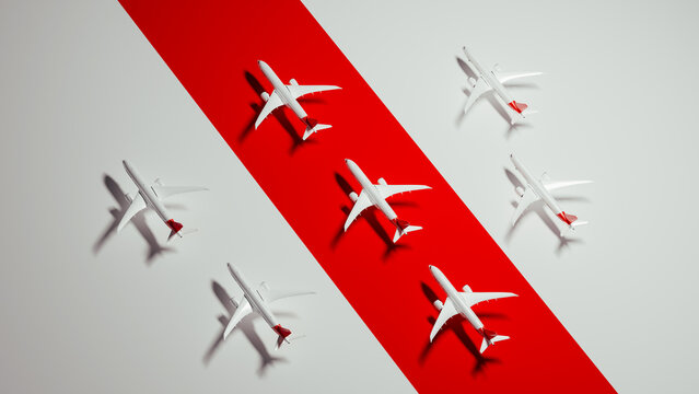 Commercial airliner models arranged on red background for travel theme