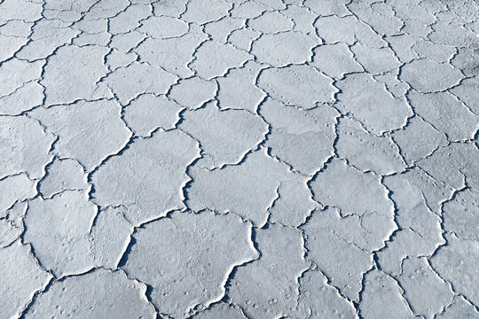 Cracked surface of dry saline mud flat from above