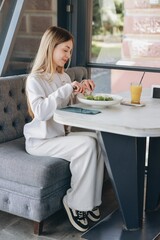 Young woman enjoying a healthy salad in a restaurant