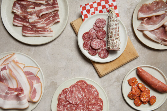 Assorted meats displayed on rustic plates for butcher theme