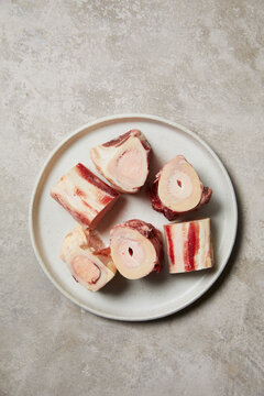 Raw Marrow Bones on Ceramic Plate for Culinary Preparation