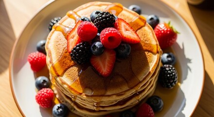 Delicious Fluffy Pancakes Topped with Fresh Berries and Syrup