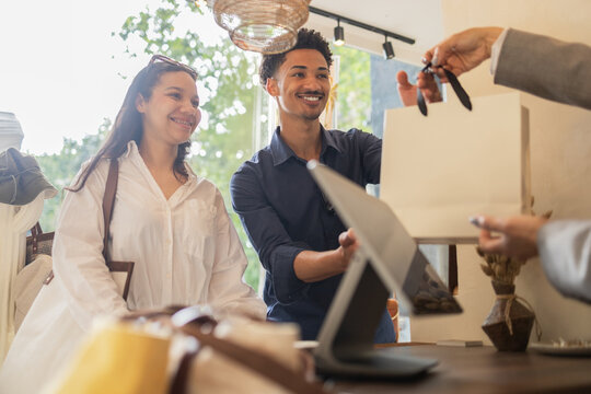 Happy customers shopping in a stylish bag store