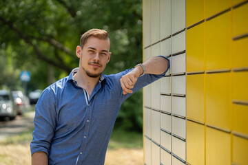 A Stylish Young Man Confidently Posing Outdoors Against a Vibrant Yellow Wall Background