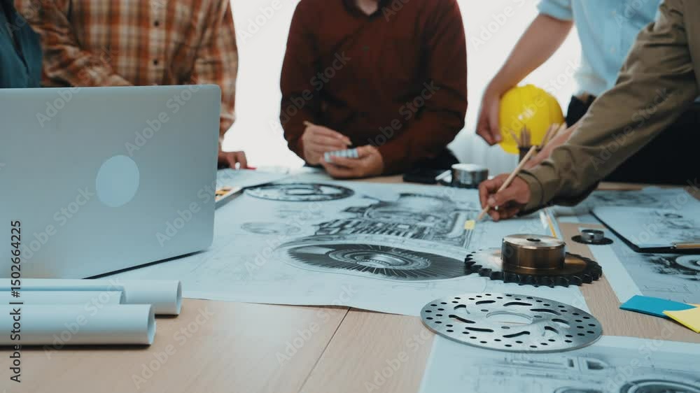 Aufkleber a group of engineers engage in collaboration, analyzing mechanical designs on a laptop while surroun